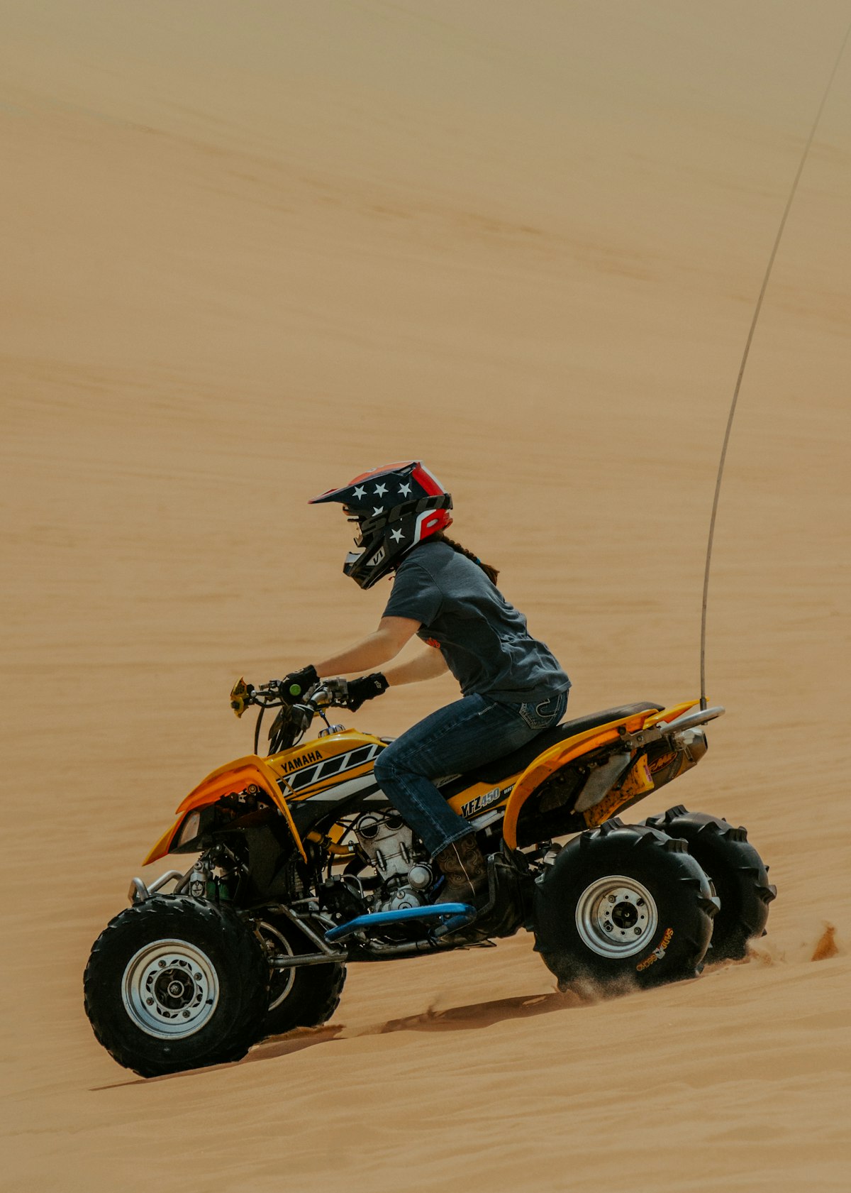 Riding quad bikes across the white sand dunes at Atlantis